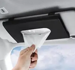 Hand pulling a tissue from an overhead car tissue dispenser mounted on the ceiling